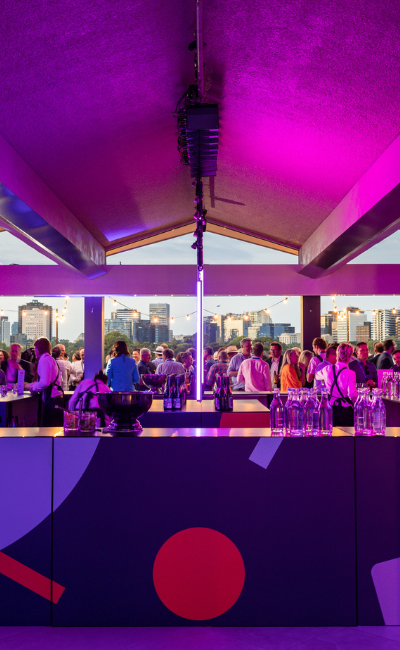 Large Melbourne event at carousel venue with vibrant neon lights, creating a lively and dynamic atmosphere