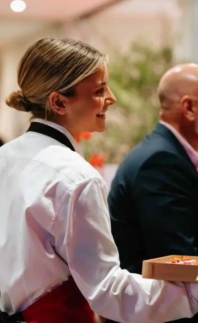 Professional Waitress Serving a Platter of Food at A Premium Event