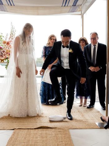 In a symbolic gesture, the groom shatters the glass, signifying the conclusion of the wedding ceremony and the joyful beginning of a new chapter in their lives as a married couple