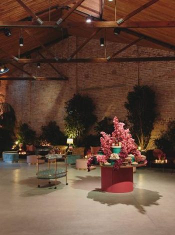 The Half Acre event space is adorned with beautiful flowers and lush plants, adding a touch of natural elegance and creating a vibrant and inviting atmosphere